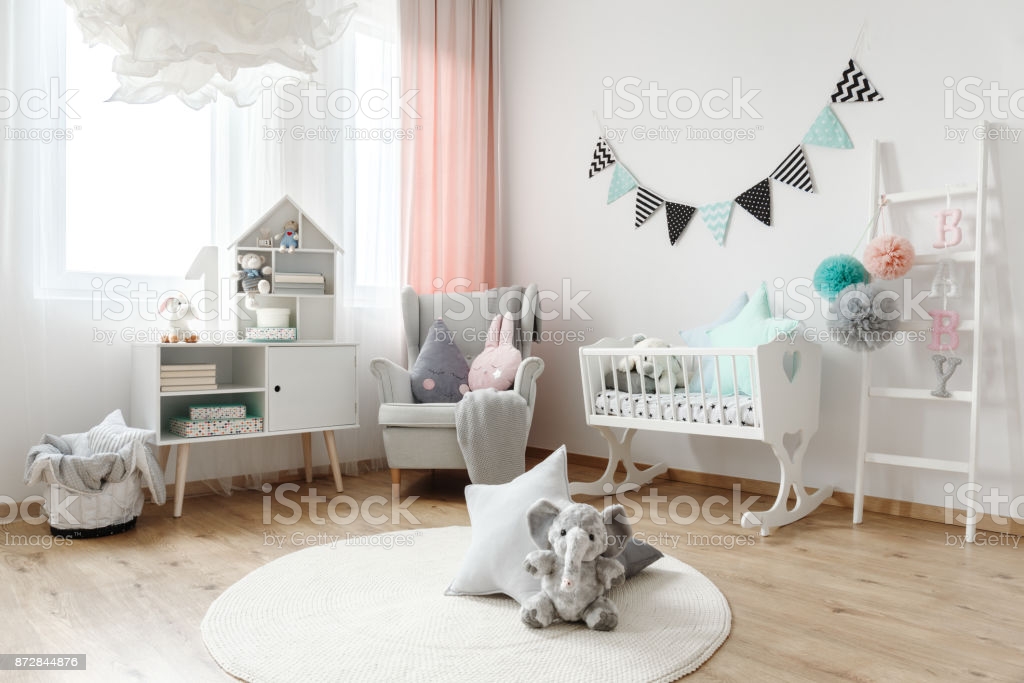 Children room interior decorated with stuffed animal toys, and colorful pillows that come in various shapes